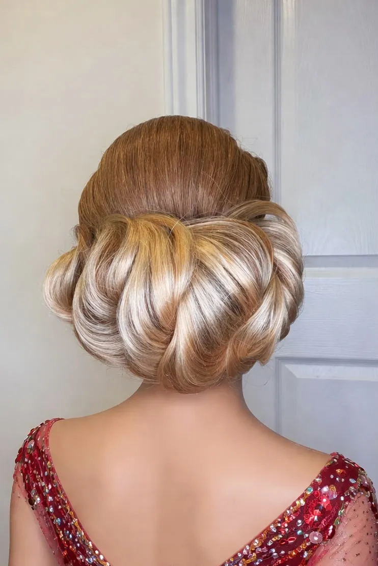 Vintage-inspired rolled updo with smooth polished sides